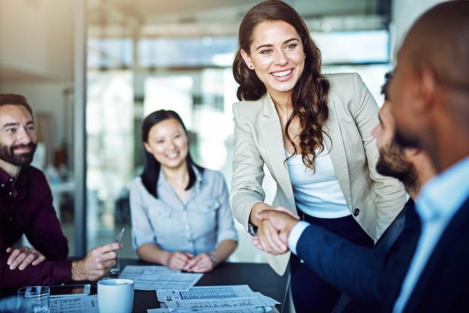 business partners shake hands after signing the contract